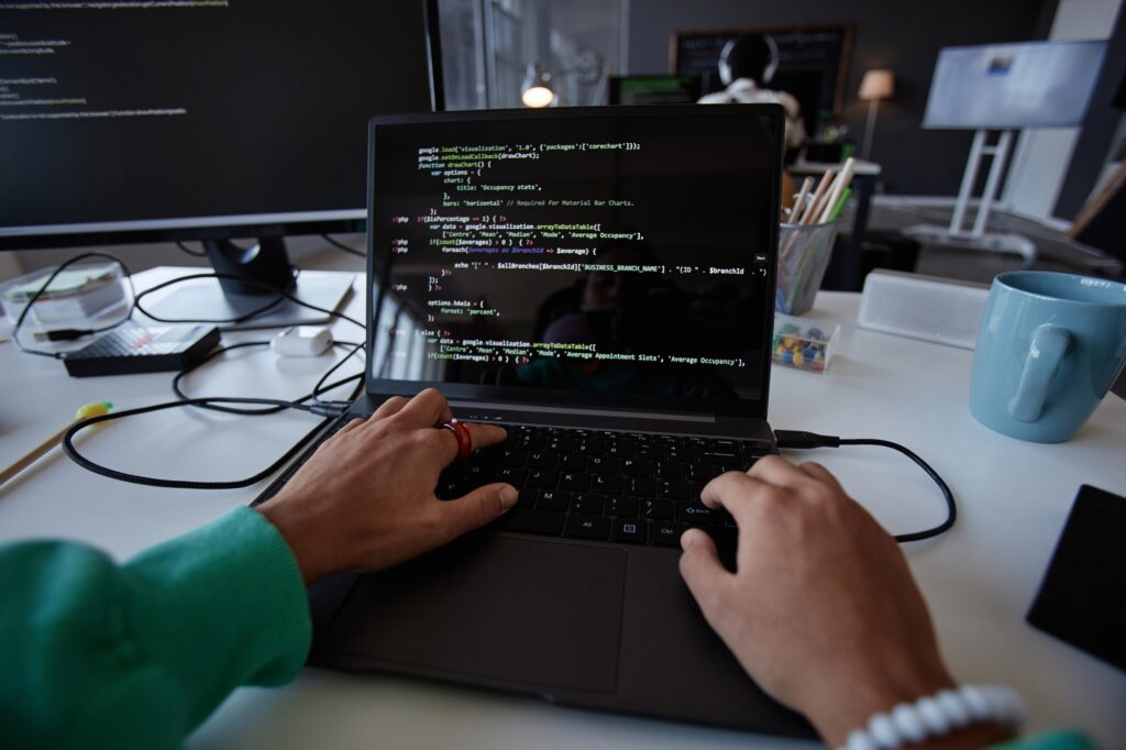 Programmer typing codes on laptop